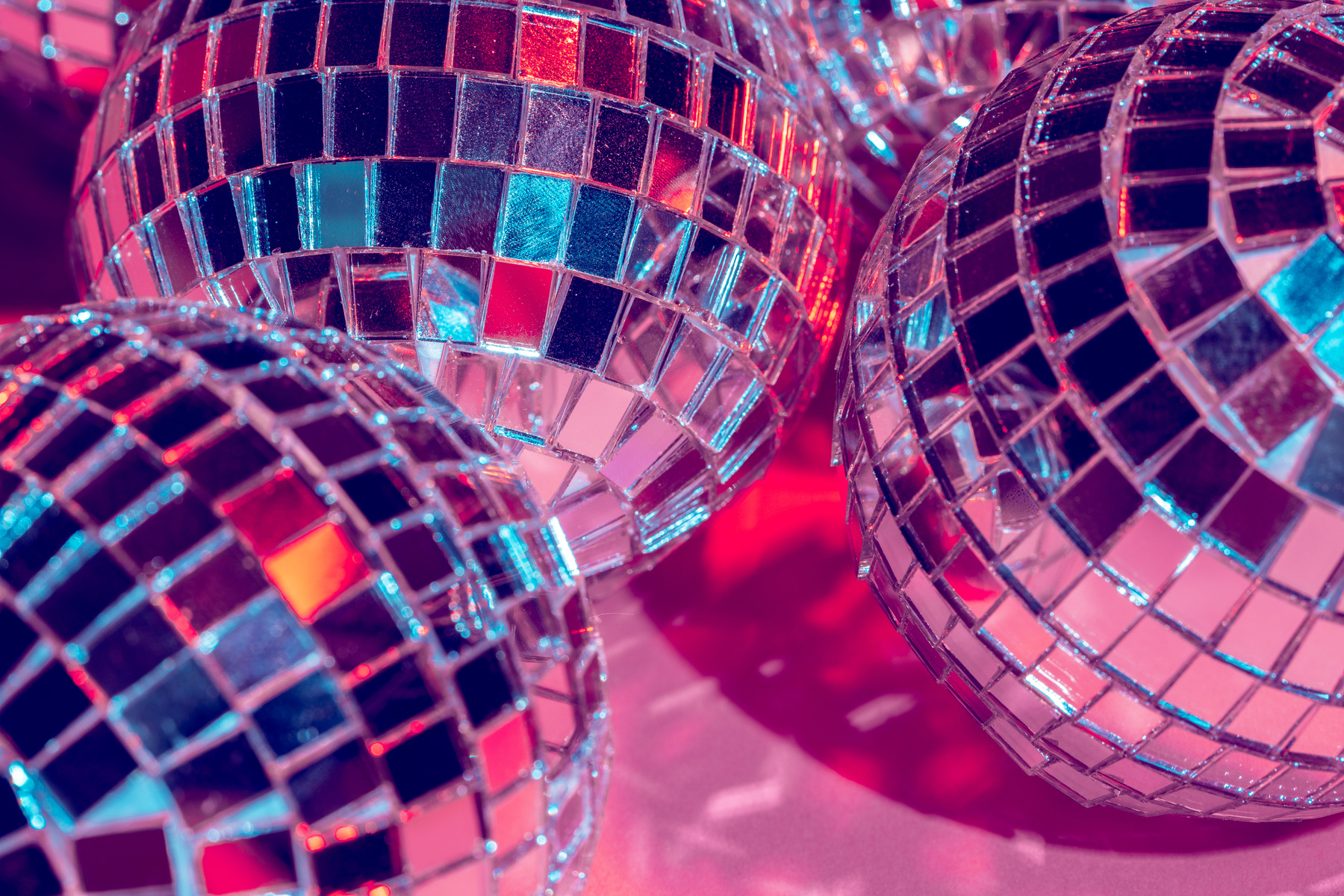 Mirror disco balls over pink background. Party, nightlife concept